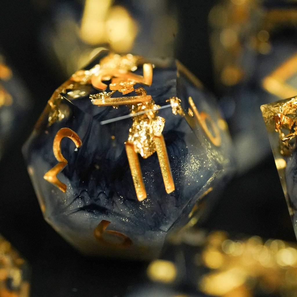 Close-up of blue and gold polyhedral dice with numbers