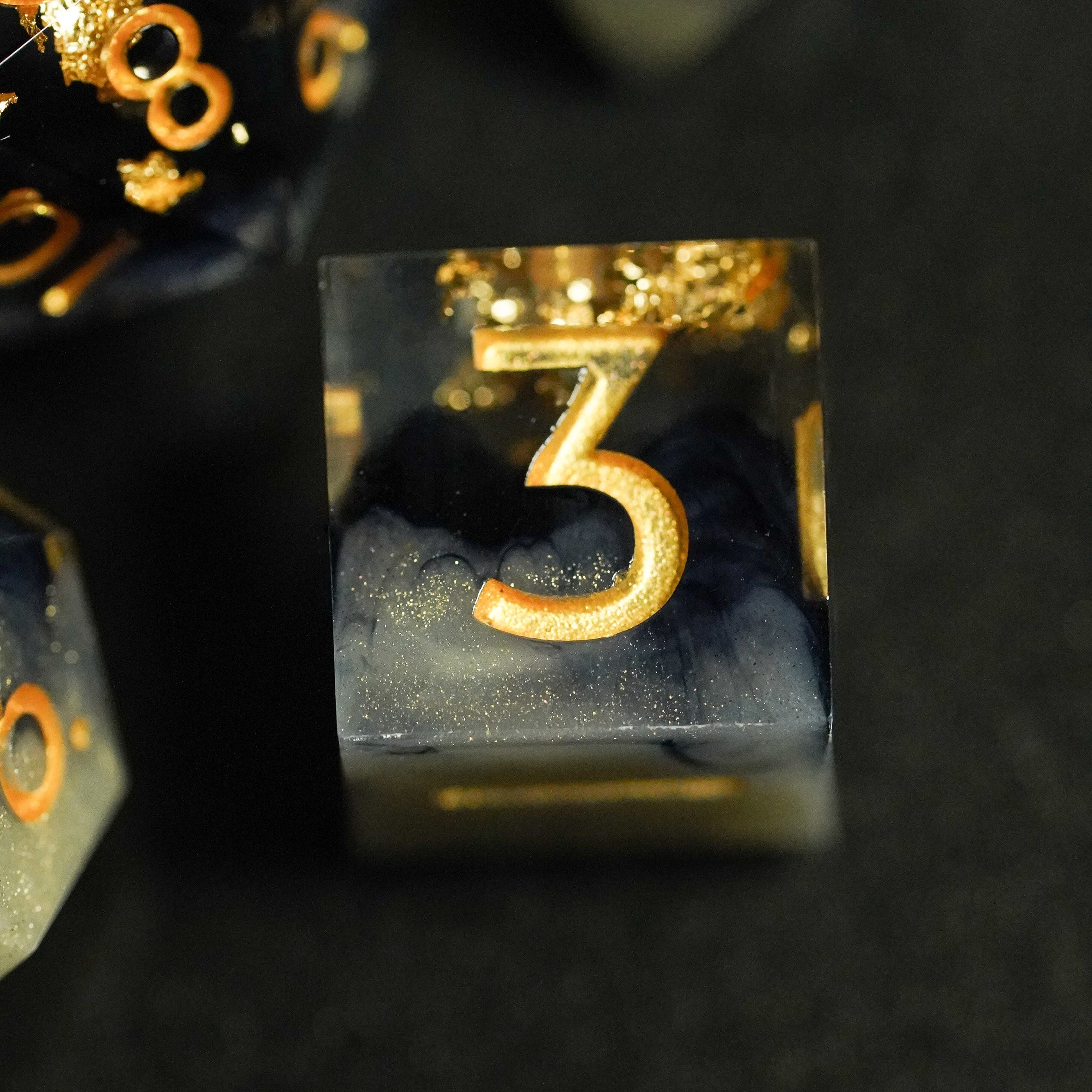 Close-up of a transparent block with a gold number '3' on a dark background