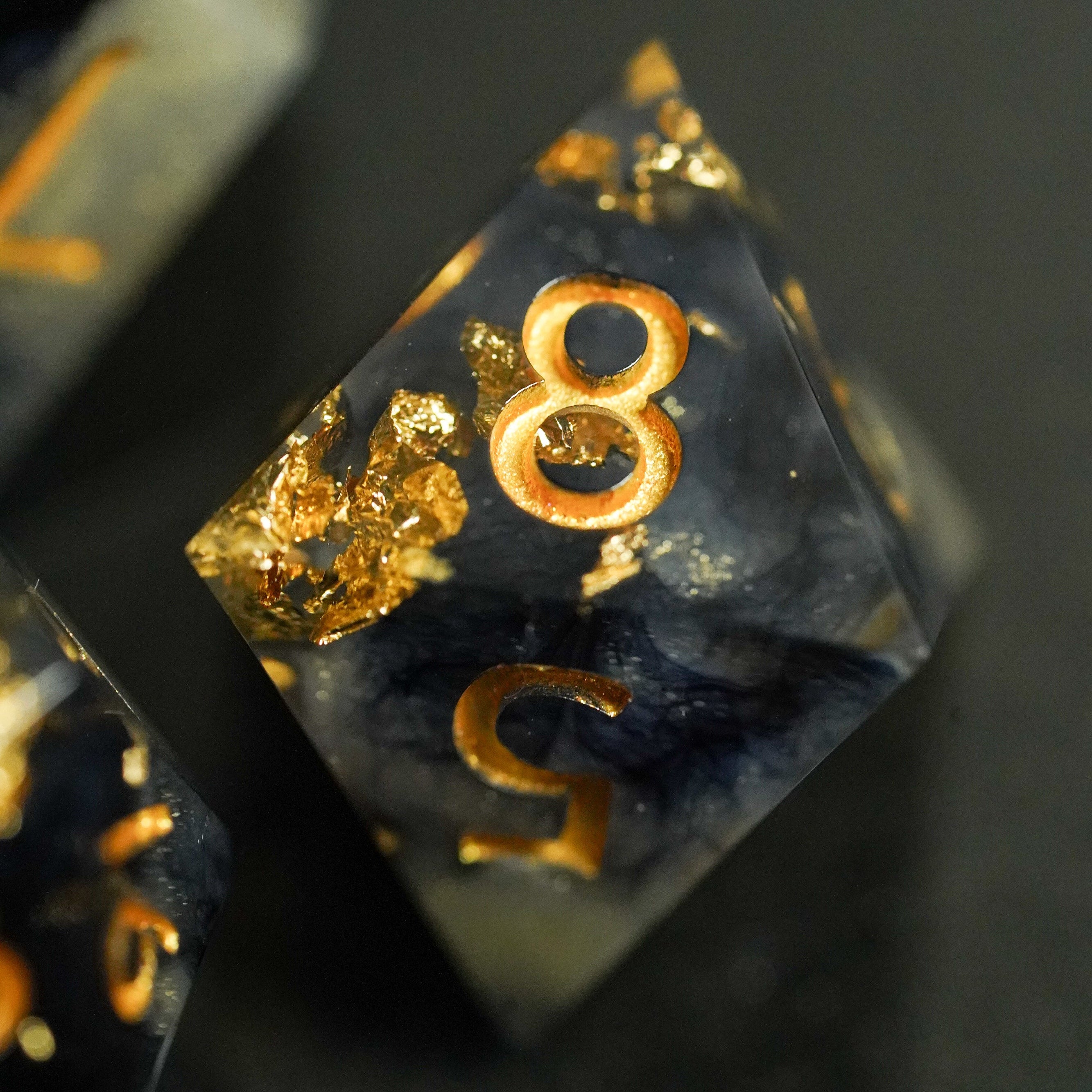 Translucent dice with gold numbers on a dark background