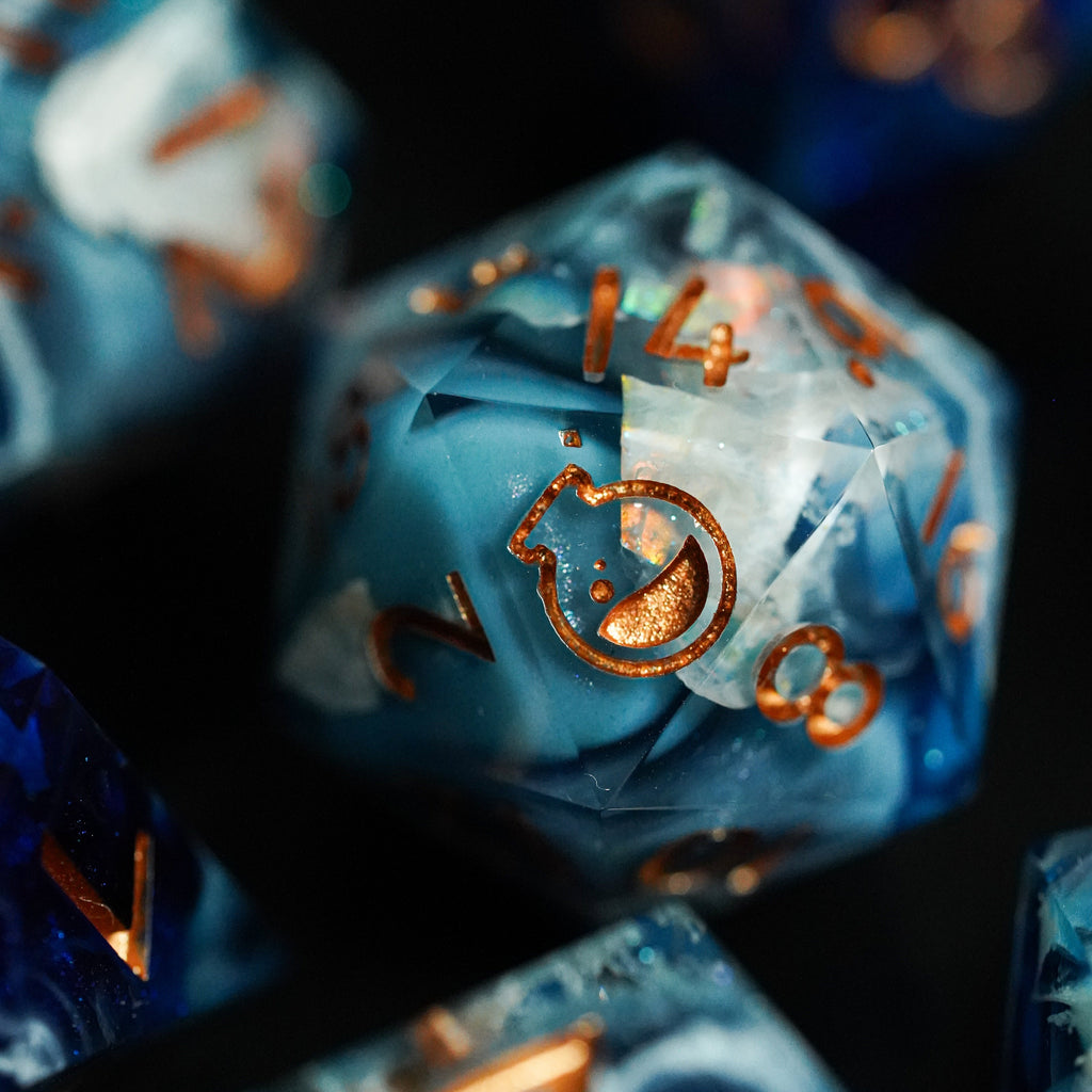 Close-up of blue polyhedral dice with copper numbers on a dark background
