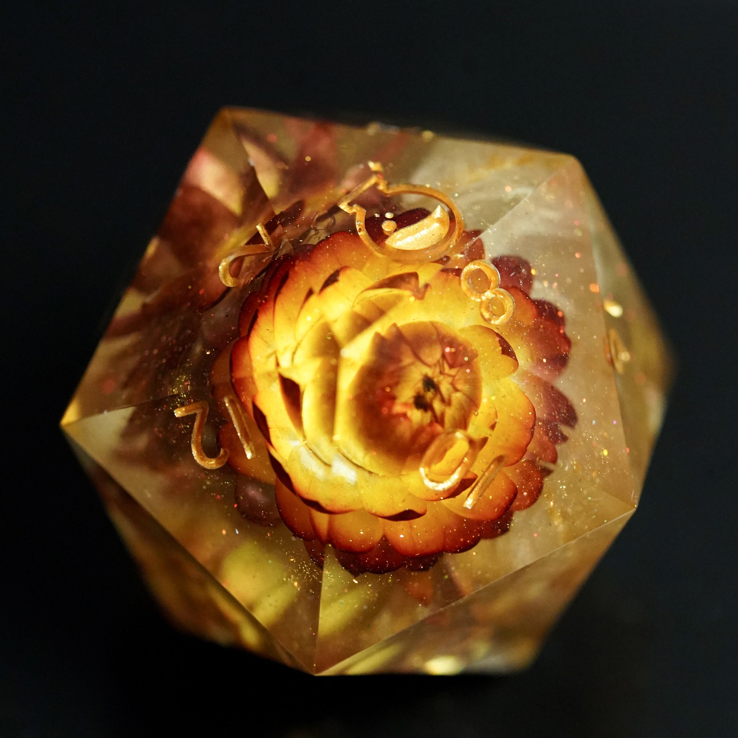 Hexagonal crystal with a rose-like design on a black background
