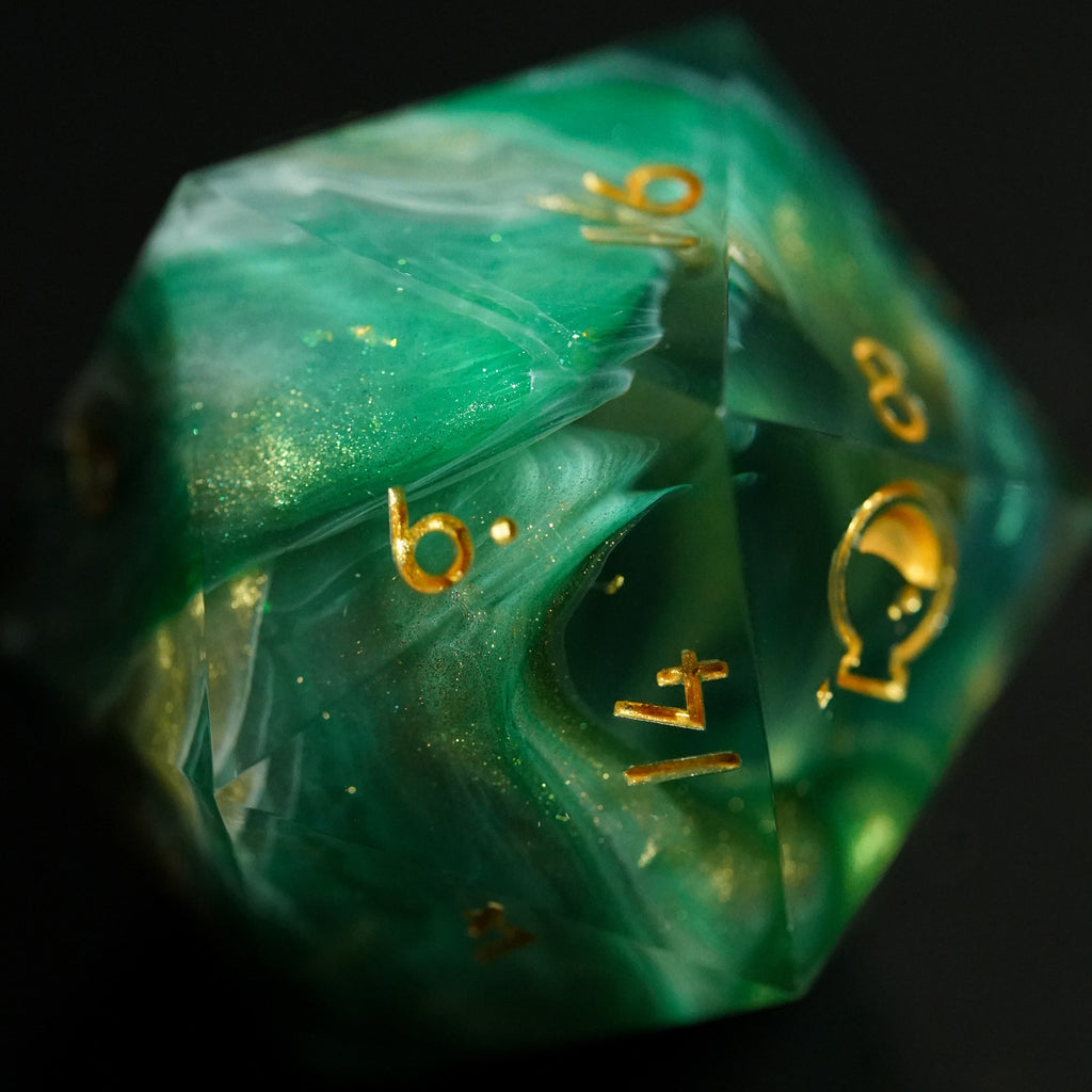 Green polyhedral dice with gold numbers on a black background