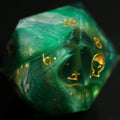 Green polyhedral dice with gold numbers on a black background