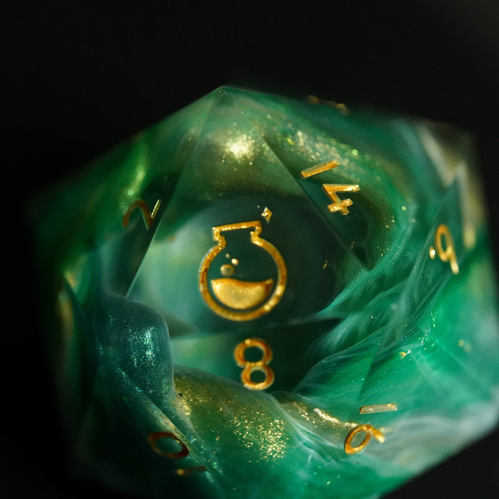 Green polyhedral dice with gold numbers on a black background
