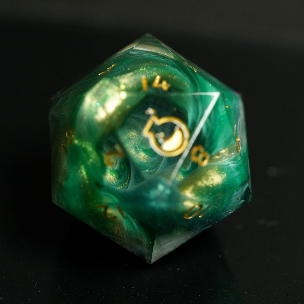Green polyhedral dice with gold accents on a black background