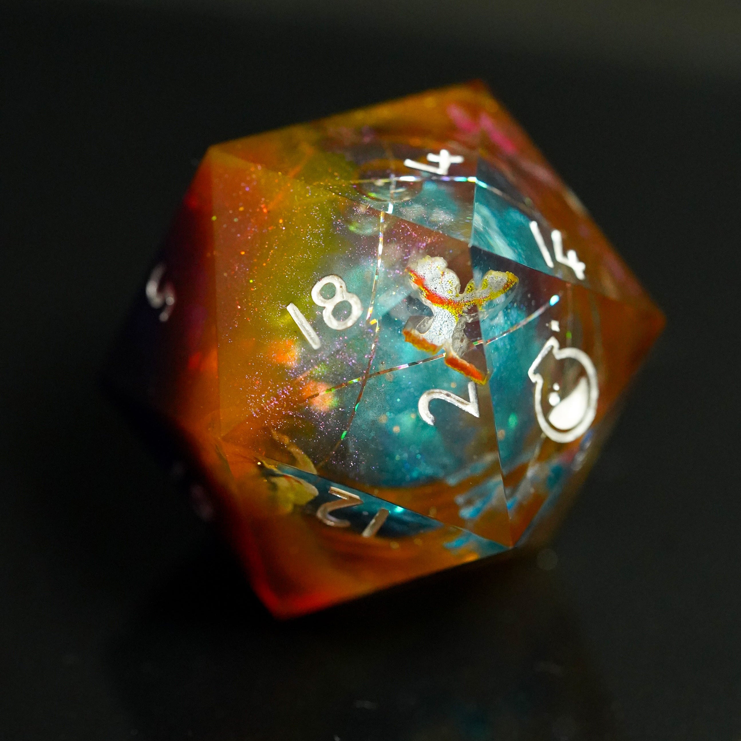 Multicolored polyhedral dice with numbers on a dark background