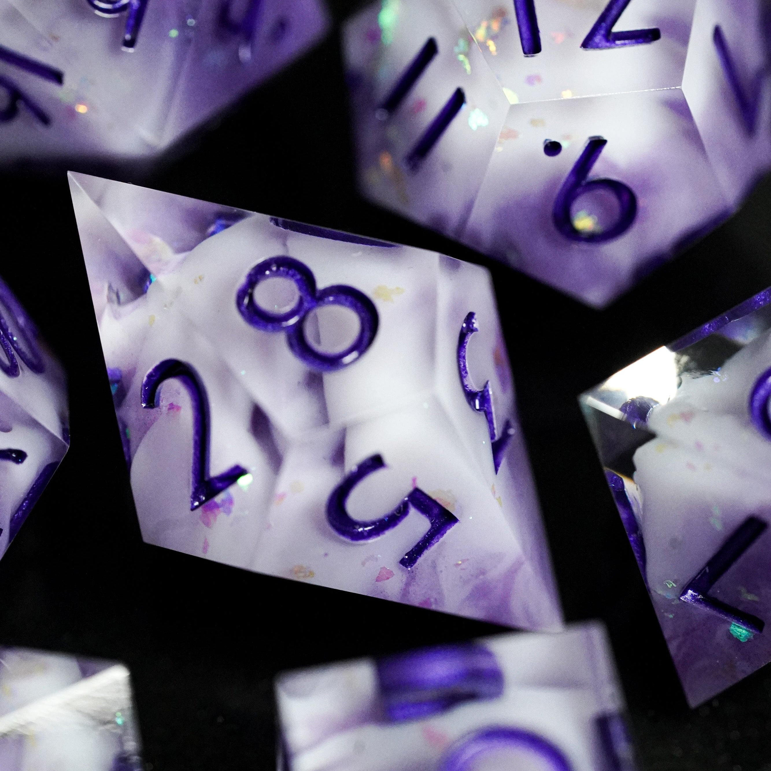 Collage of purple polyhedral dice with numbers on a black background