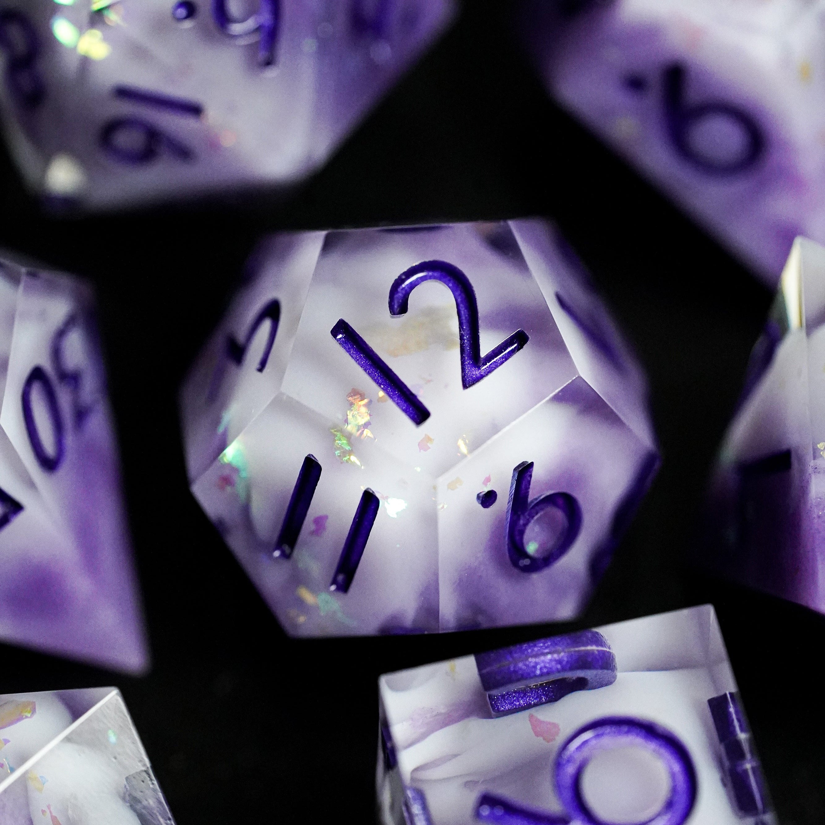 Close-up of purple and white dice with numbers on a black background