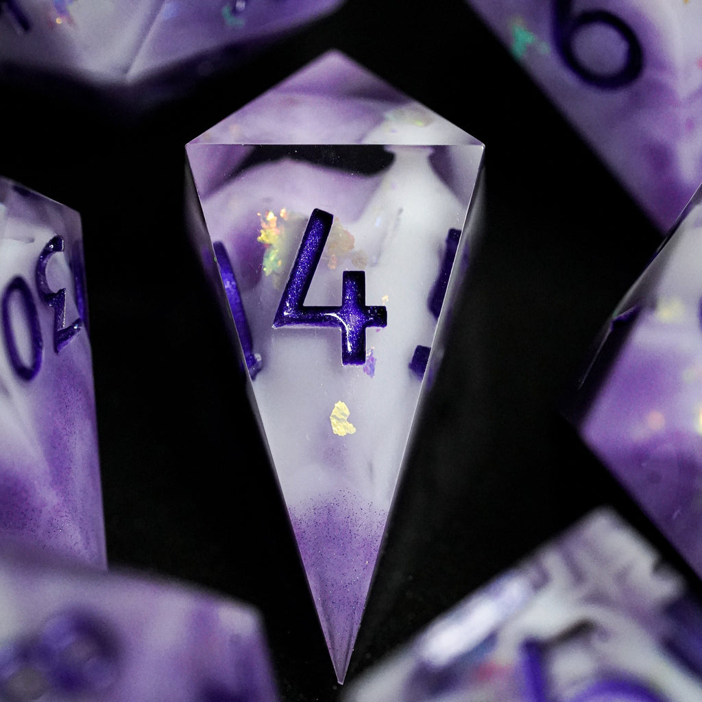 Close-up of purple and white polyhedral dice with numbers