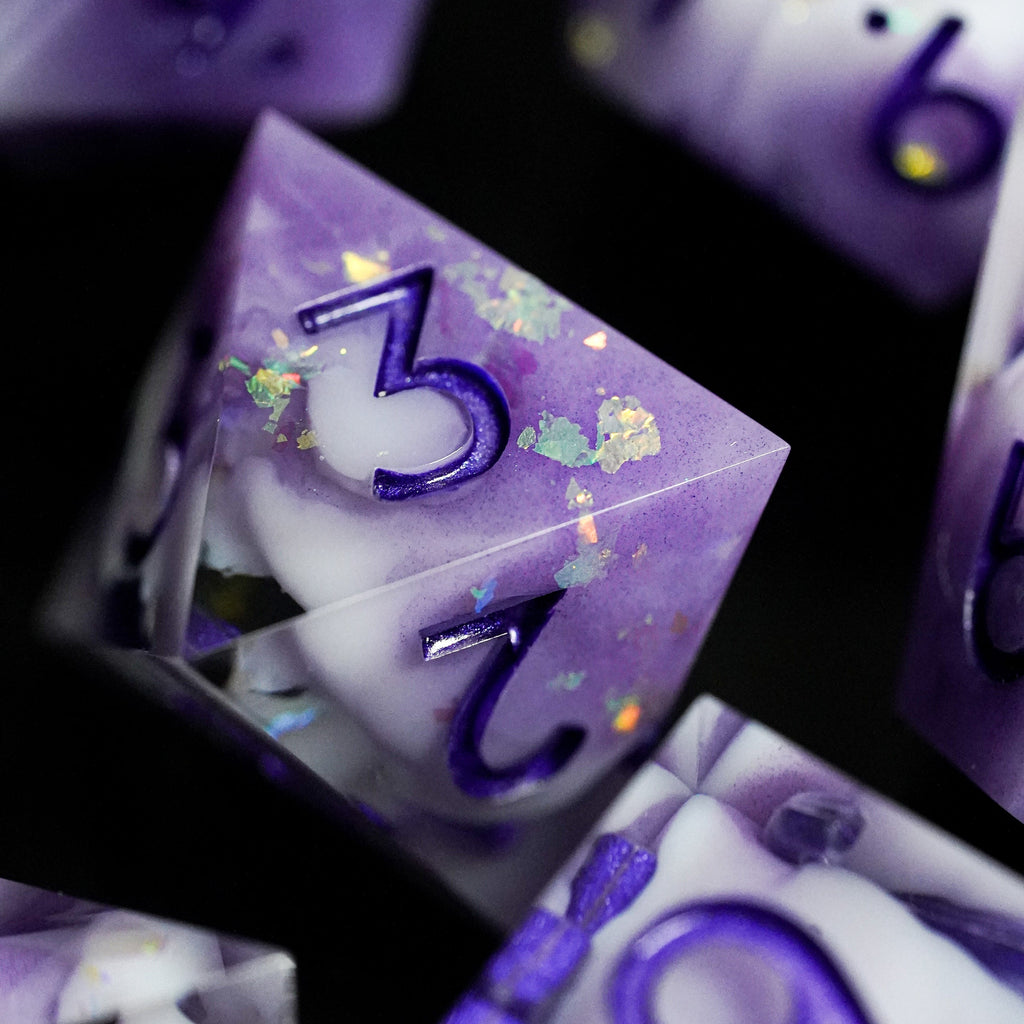 Purple and white dice with numbers on a dark background