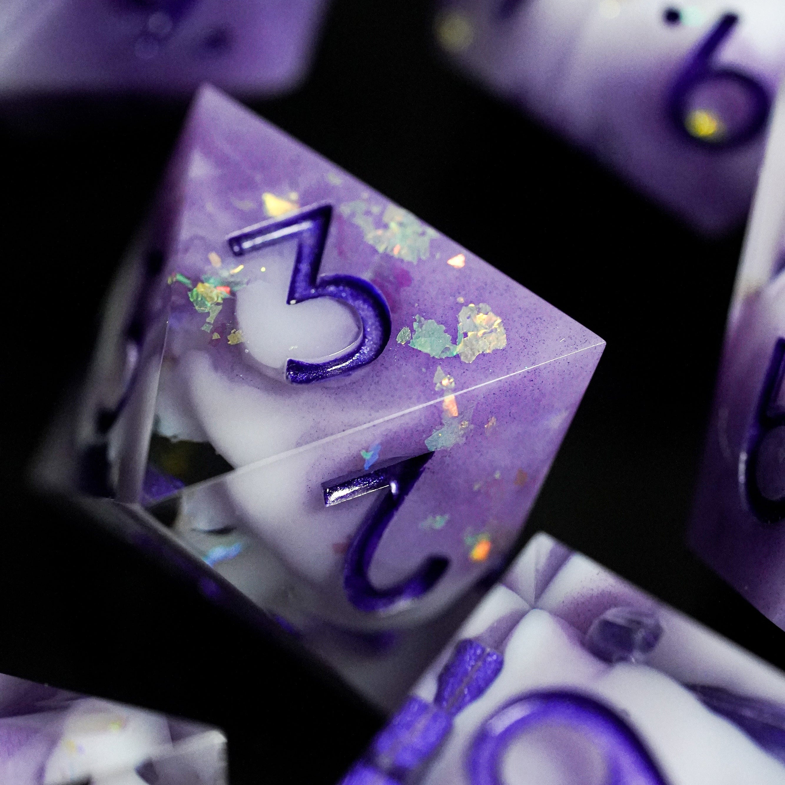 Purple and white dice with numbers on a dark background