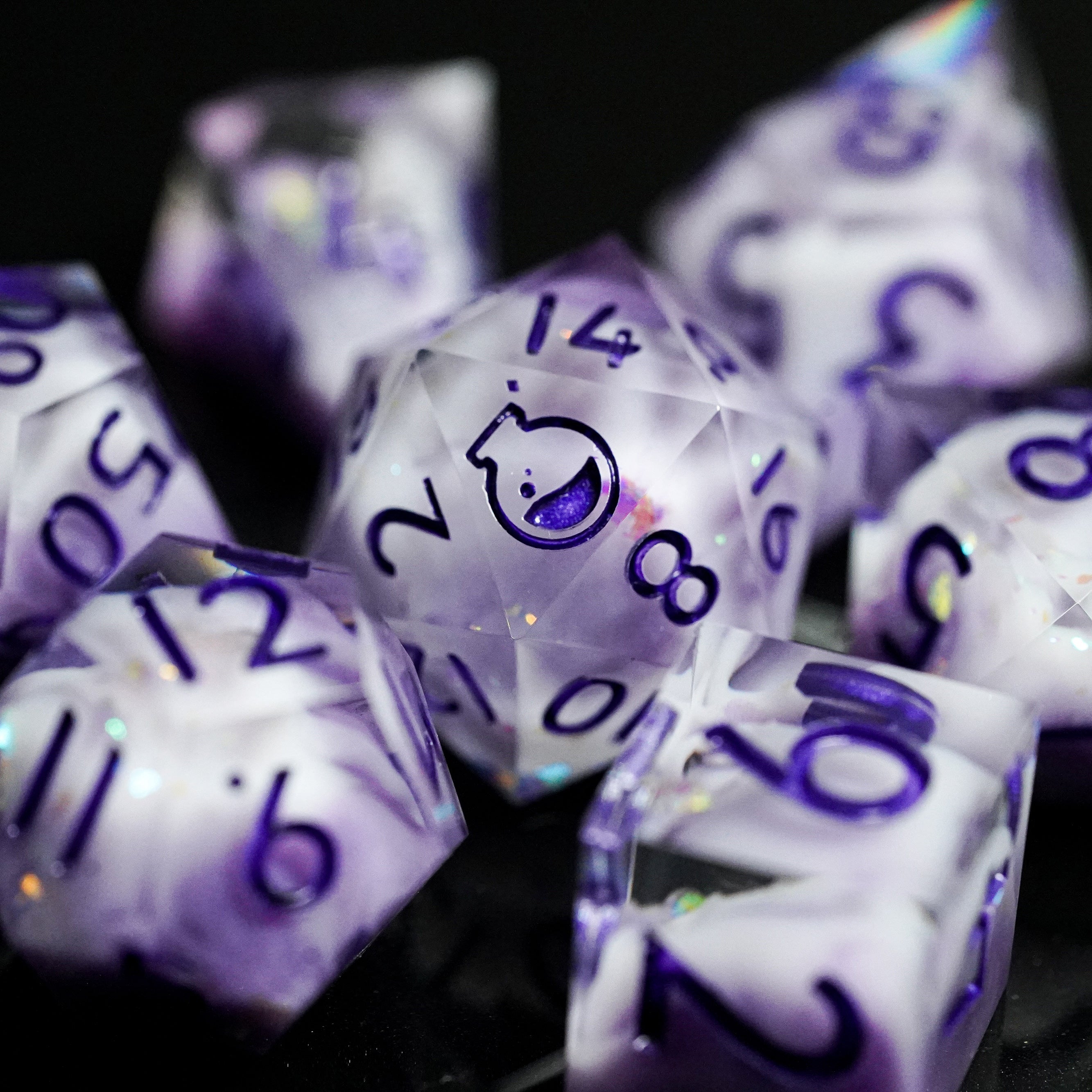 Purple polyhedral dice set with white numbers on a dark background
