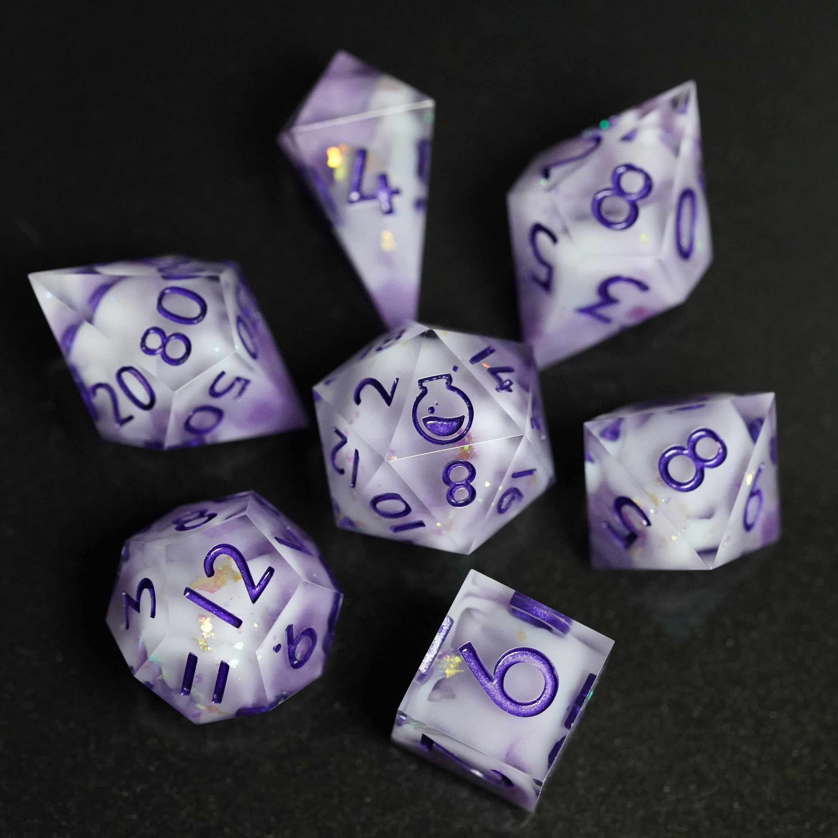 Set of purple polyhedral dice with white numbers on a black background