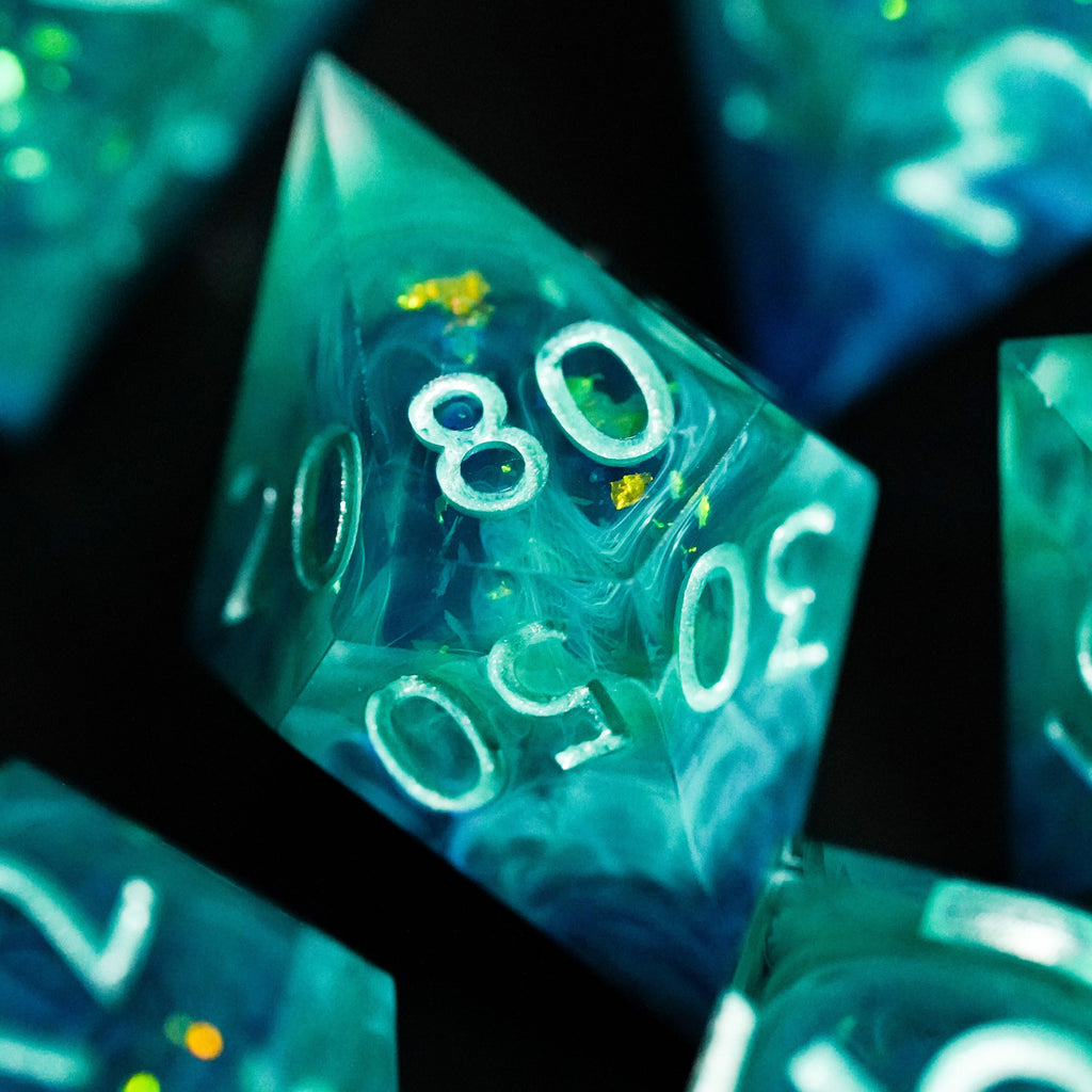 Close-up of translucent green polyhedral dice with white numbers on a dark background