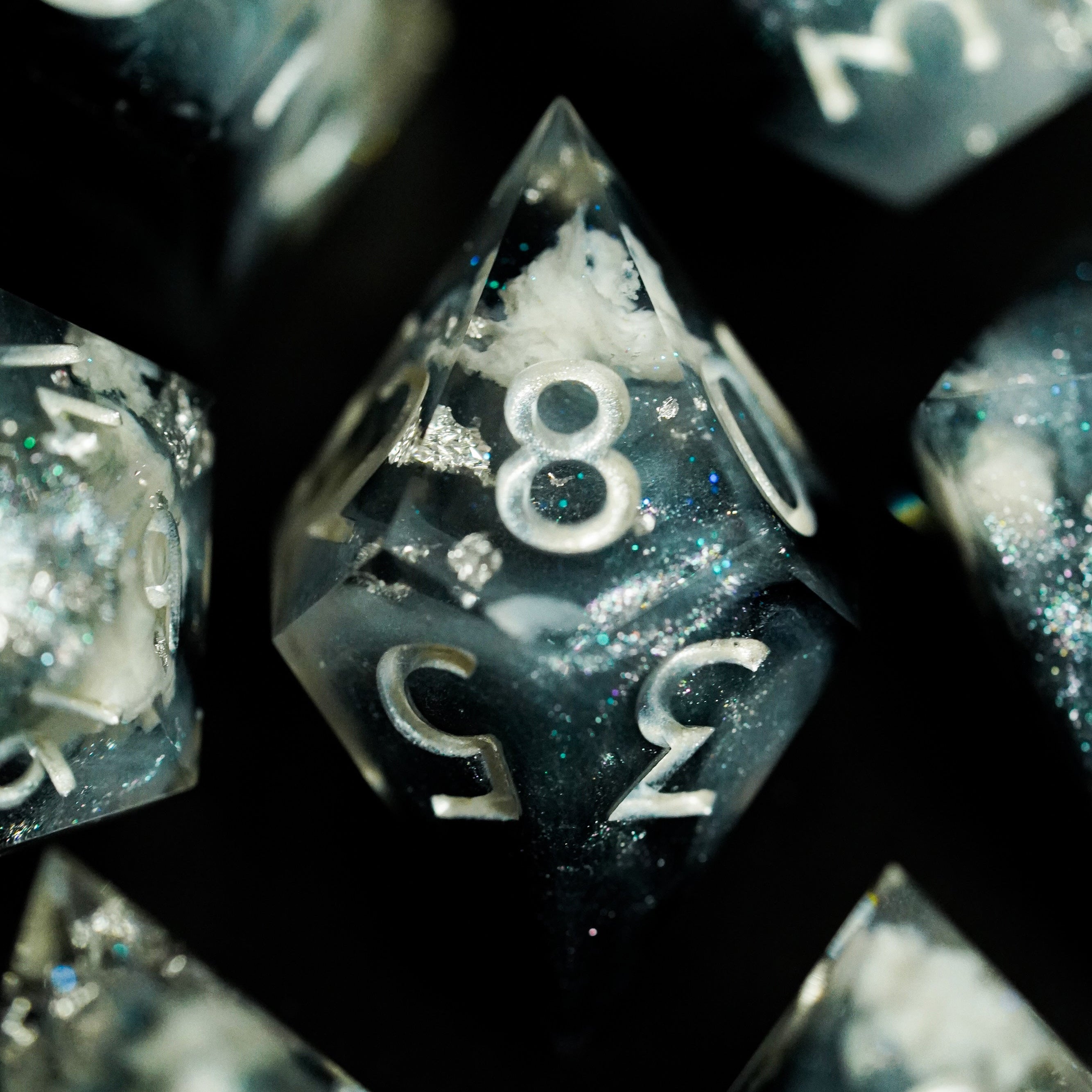 Close-up of polyhedral dice with numbers on a dark background