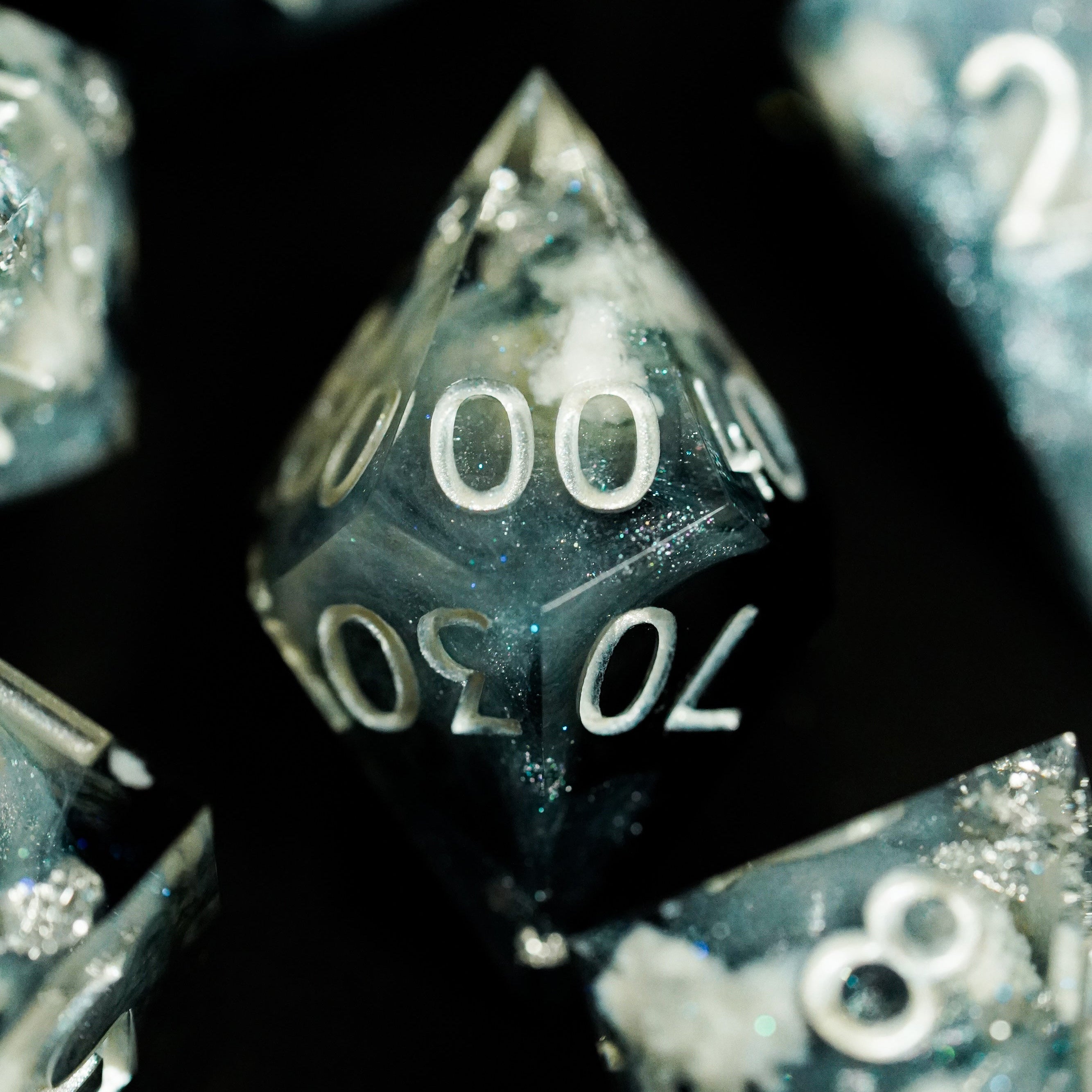 Close-up of translucent dice with numbers on a black background