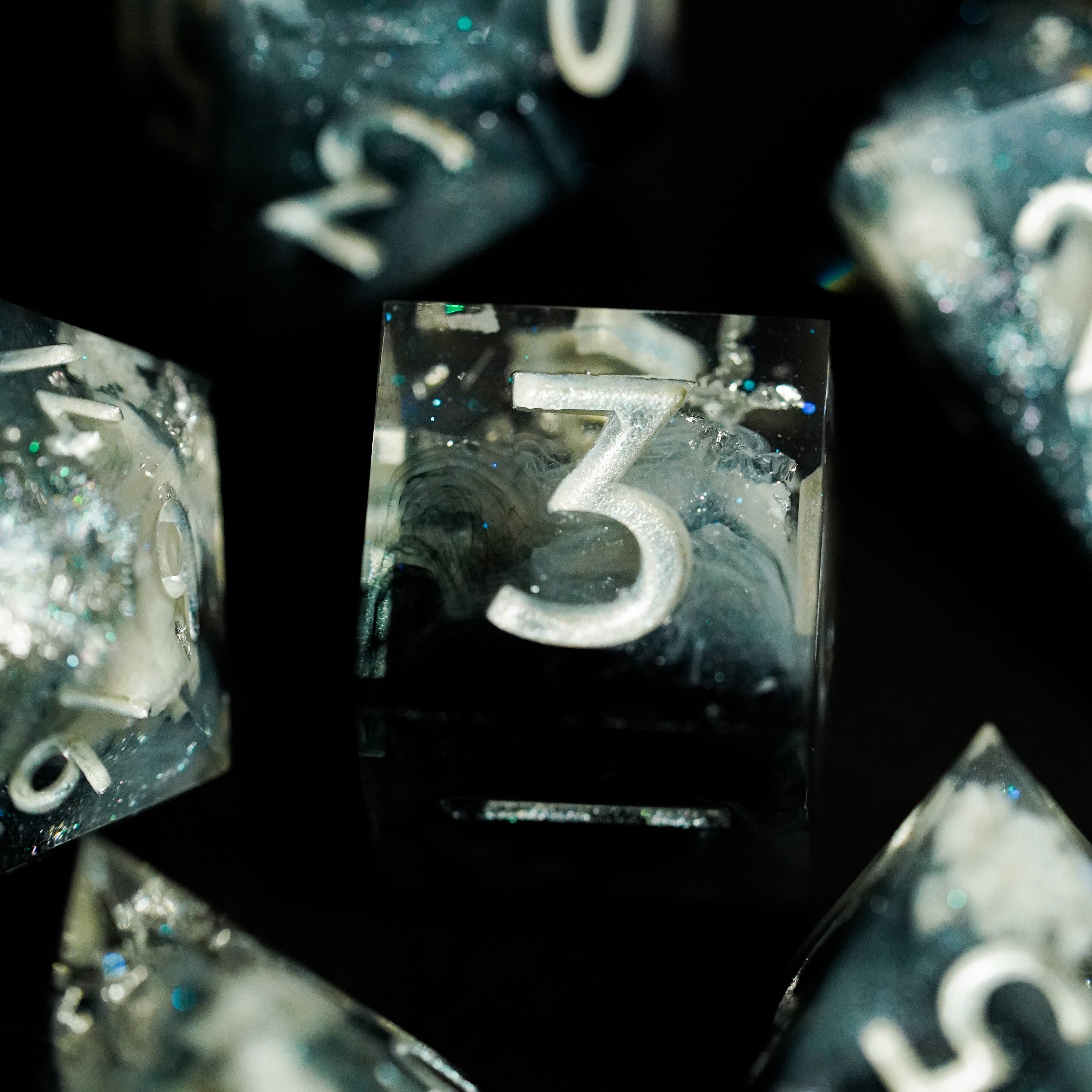 Close-up of black dice with white numbers on a dark background