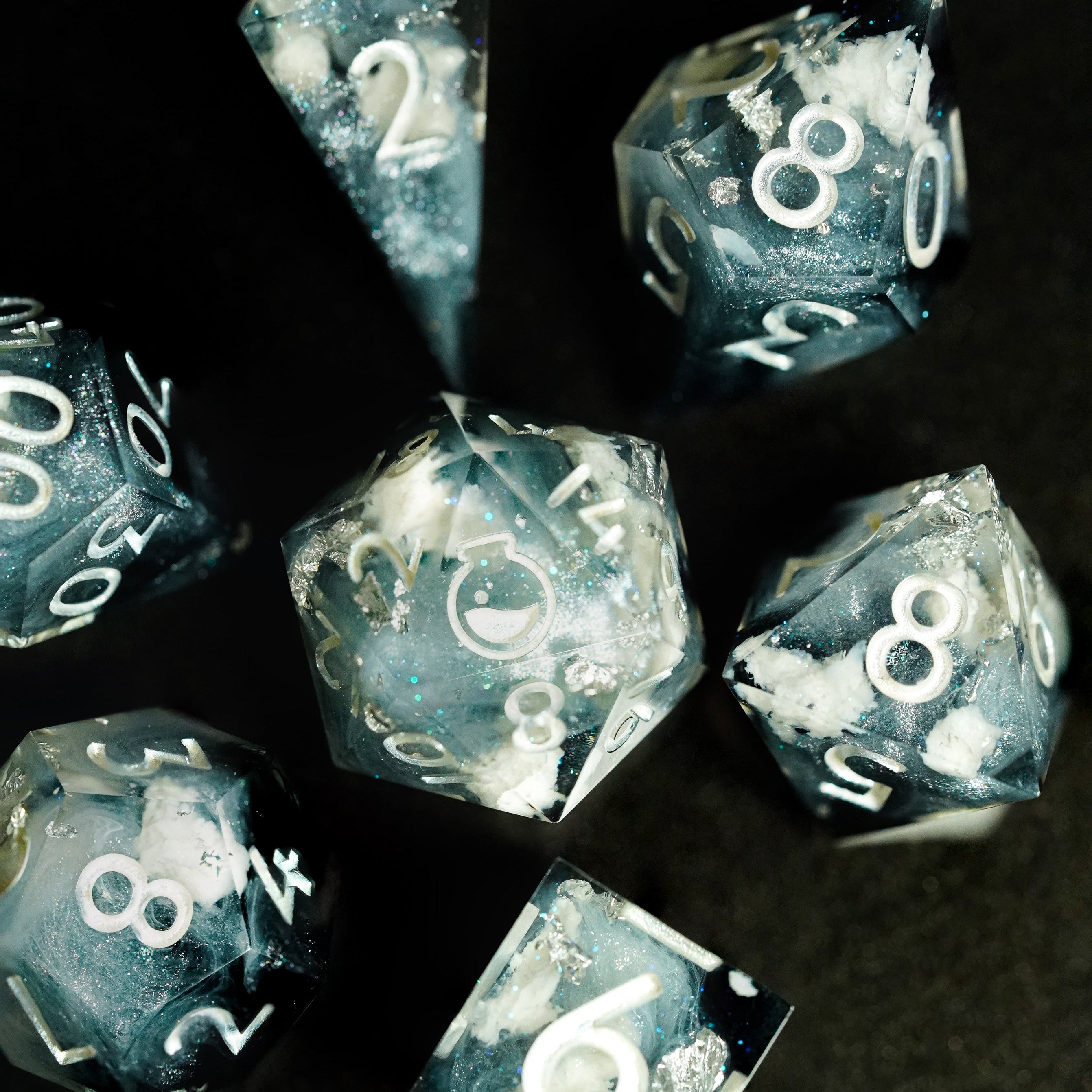 Set of dice with white numbers on a dark background