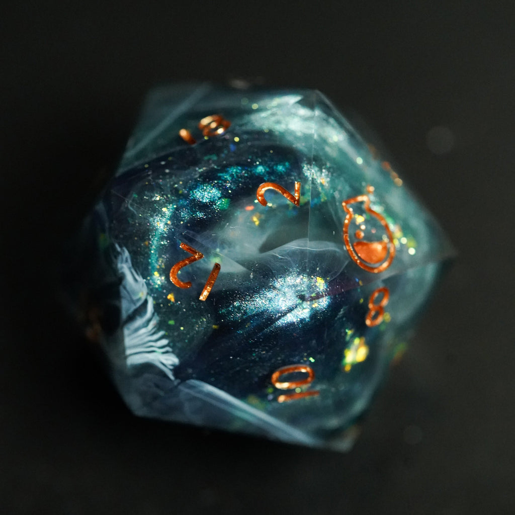Close-up of a blue polyhedral die with gold numbers on a dark background