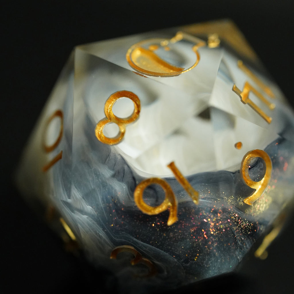 Translucent dice with gold numbers on a black background