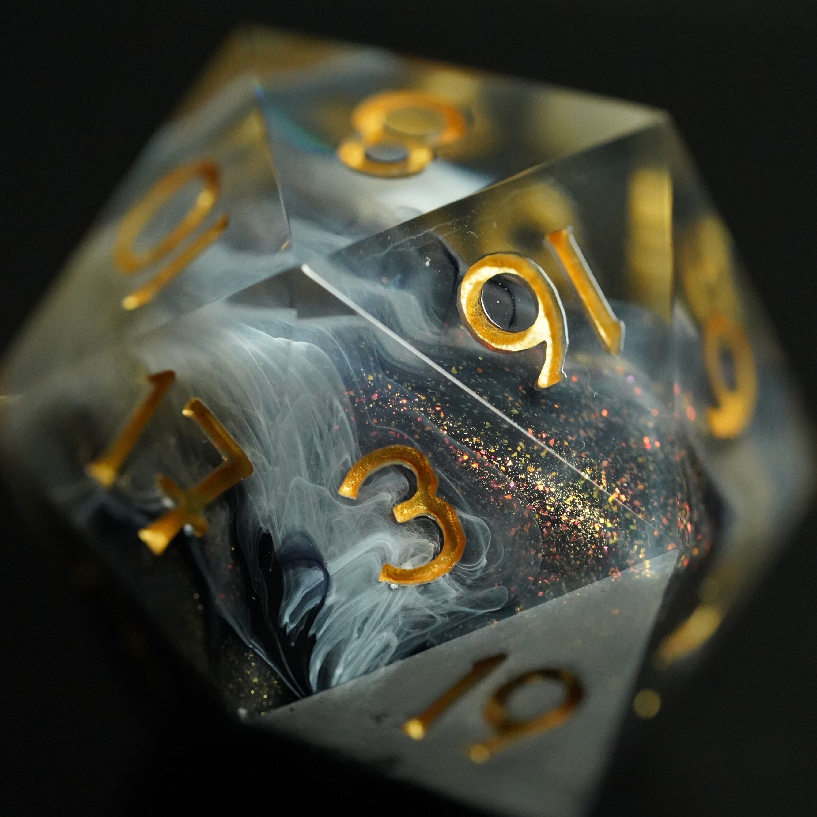 Translucent dice with gold numbers on a dark background
