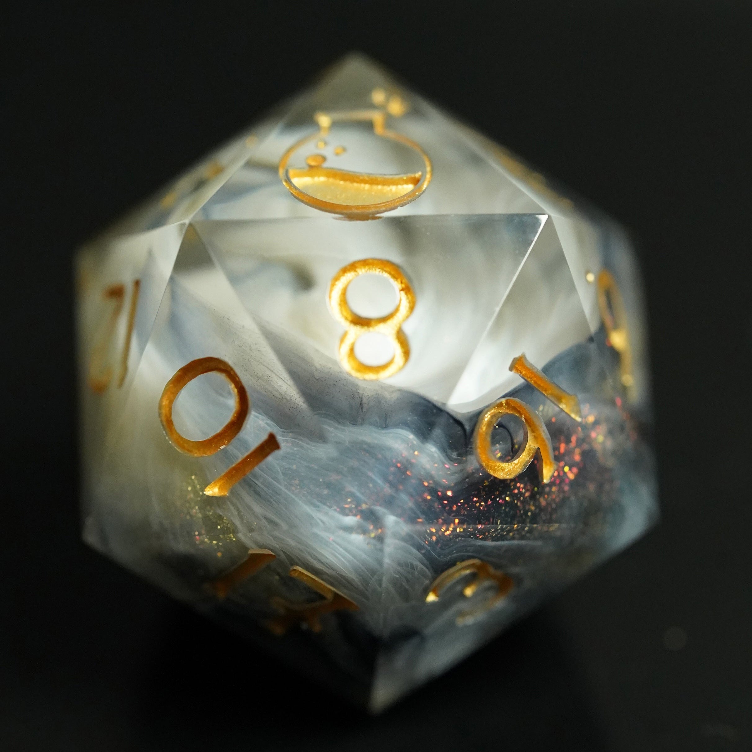 Translucent dice with gold numbering on a dark background
